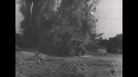 1940s: Explosion in field. House explodes, collapses. Sign on door, zoom in on Stock Footage 113947202