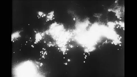 1940s: Explosions and fire at night. French flag from Arc de Triomphe. Crowds Stock Footage 167959384