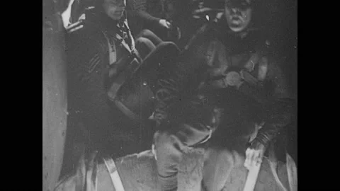 1940s: Fighter jets fly in formation. Airmen parachute from plane. Video stock 150348491