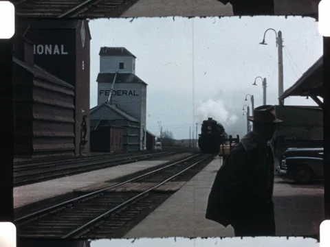 1940s film of a train pulling into station. 16mm 2k overscan Stock Footage 283757197