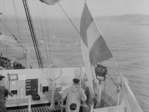 1940s: Flags hoisted on ship Stock Footage 221381741