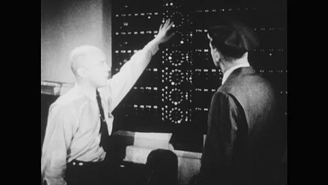 1940s: Flight operator points at large switchboard. Pilot picks up data report Stock Footage 75164933