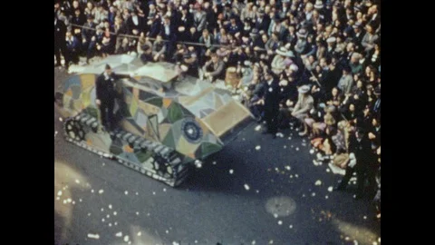 1940s: Float shaped like a tank in parade, stops and shoots smoke. Float shaped Stock Footage 89553013