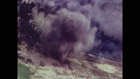 1940s: Flying in plane, bomb explodes on ground. Fire burns from destruction on Stock Footage 158439303