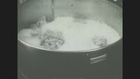 1940s: Food in boiling water, Food fills bucket, Cans are filled with oysters Stock Footage