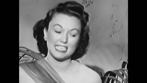 1940s - Ginny Simms sings "I Don't Stand a Ghost of a Chance with You." Video stock 246360183