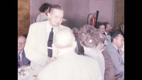 1940s: Guest of honor circulates in function room full of smiling guests, posing 스톡 동영상 95850061