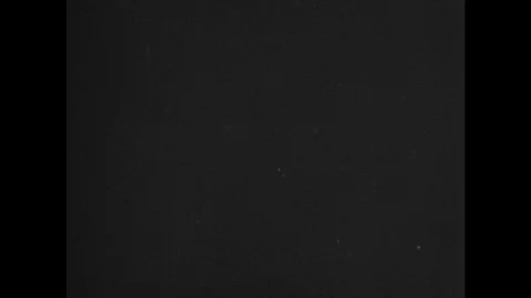 1940s: gun blast at night. Pilot talks on radio. Plane glides towards enemy Stock Footage