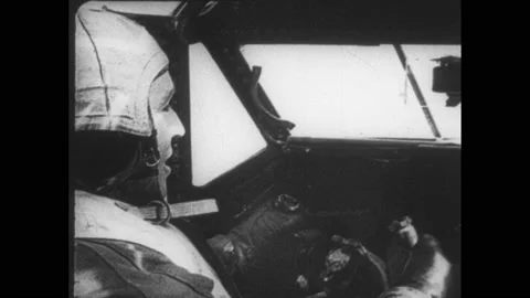 1940s: Gunner in turret gesturing. Pilot in cockpit. Aerial shot plane wing over Stock Footage 152534144