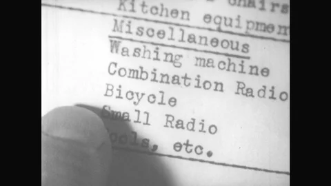 1940s: Hand Runs Finger Along List Of Inventory. Man Shows Paper To Man At Desk. Stock Footage