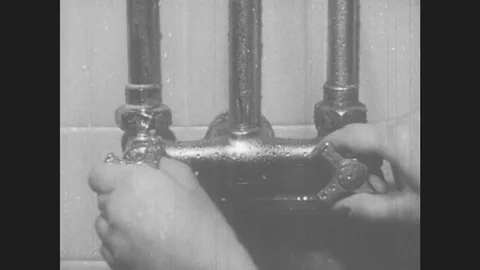 1940s: Hands adjust shower knobs. Girl turns face into shower stream. Girl 스톡 동영상 78459312