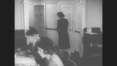 1940s: Hostess leads group of women diners to round table. Hostess seats women. Stock Footage