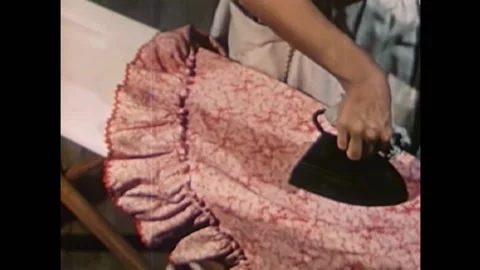1940s housewives does the difficult back breaking task of ironing in the home. Stock Footage 157263844
