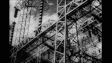 1940s: Hydroelectric dam under construction. Power grid. Wheat field. Calf and Vídeo Stock 167959369