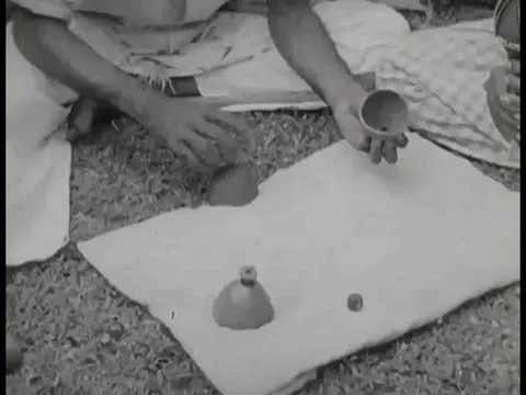 1940s- An Indian magician performs the shell game. Stock Footage 79457219