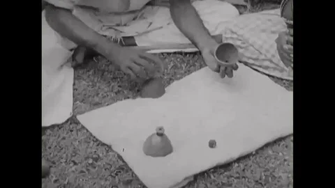 1940s An Indian magician performs the shell game. Stock Footage 115664228