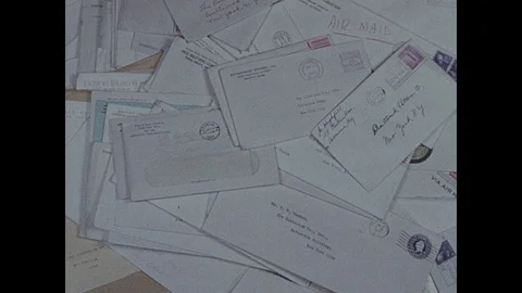1940s: Letters fall onto pile. Stock Footage 94619560