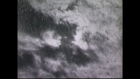 1940s: Lighting flashes, rain, thunder, stormclouds. Man opens door of fort, Stock Footage 90560400