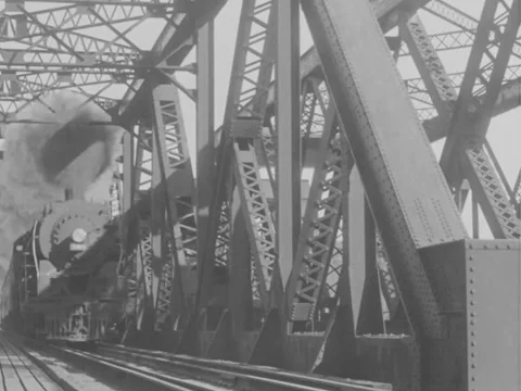1940s: Low-angle train over steel bridge Video stock 158174783