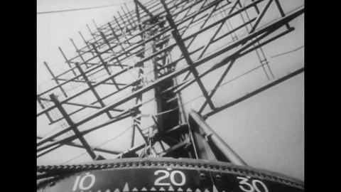 1940s: Low angle view of radar antenna / Man looks at radar screen / Pan to wall Vídeo Stock 74507833