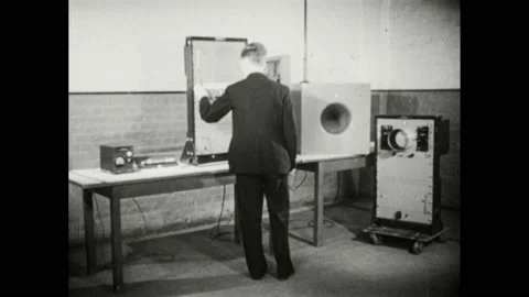 1940s: Man adjusts knobs on Geiger counter and meters in workshop. Man adjusts 스톡 동영상 169234035