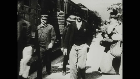 1940s: Man cranks handle on projector and screen shows the Lumiere film The Vidéo 130359178