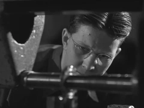 1940s: Man inspects machine Stock Footage 231722347