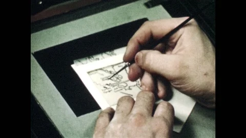 1940s: Man paints slide on lightbox.  Man wipes brush on towel. Stock Footage 94221908