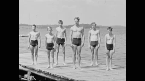 1940s: Man practices all elements of front crawl in lake in slow-motion. Group Stock Footage 163562122