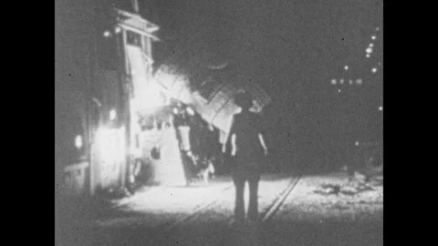 1940s: Man stands in front of machinery, sparks fly. Poliemen on horseback Stock Footage 88641655