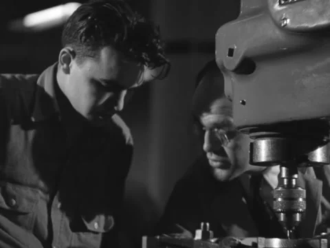 1940s: Man taught how to use electric drilling machine Stock Footage 231723778