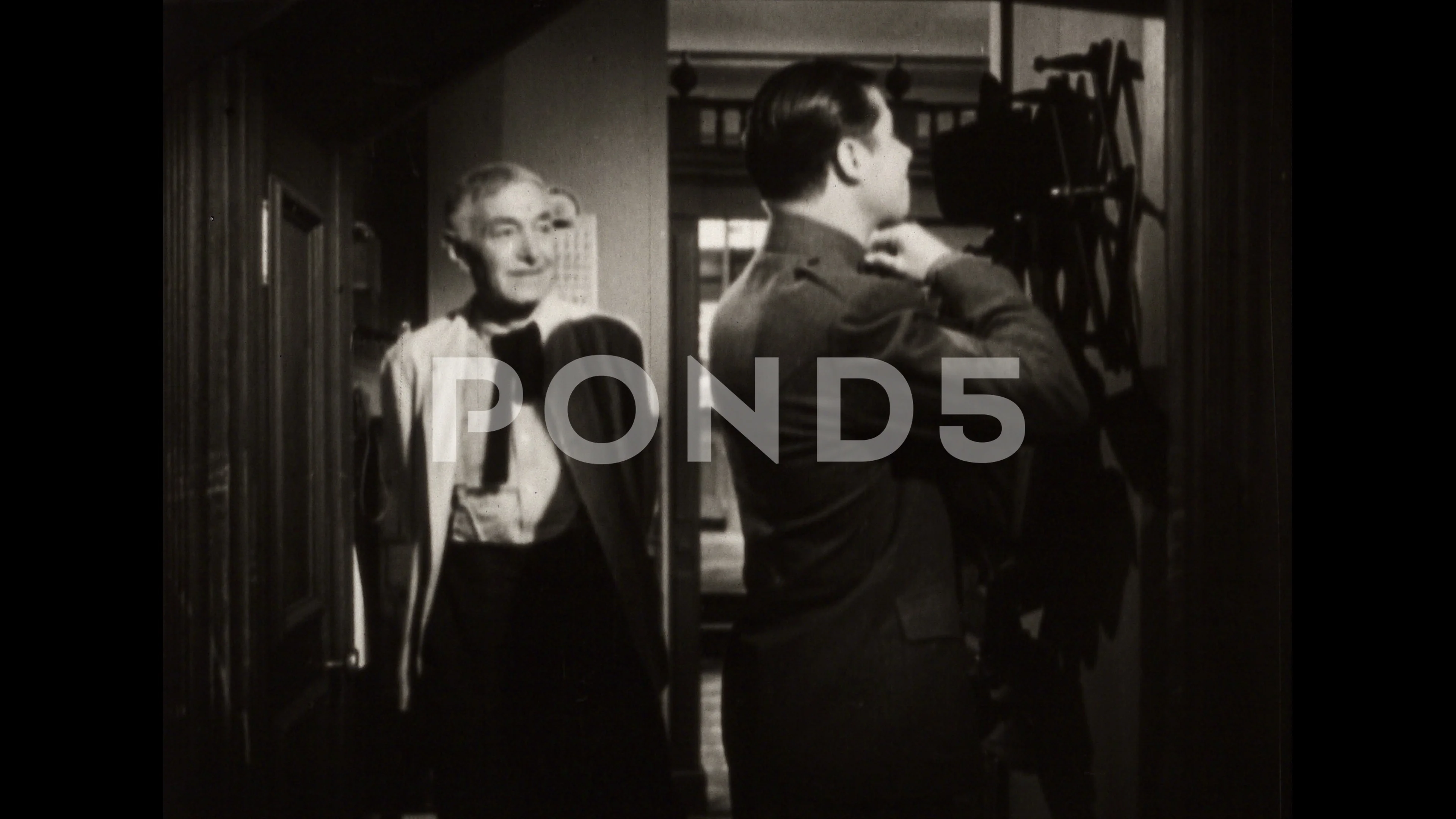 1940s: Man undressing in hallway, man enters, men talk, men walk into room,  man