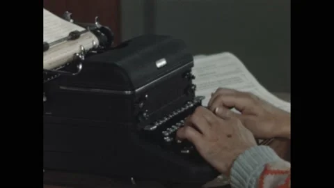 1940s: Man's hands type on the keys of a typewriter, pull out the paper and set Stock Footage 195119501
