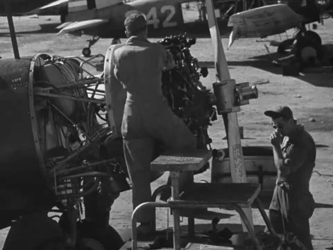 1940s: Mechanics doing maintenance to plane on tarmac at Gunter Field Stock Footage 231814030