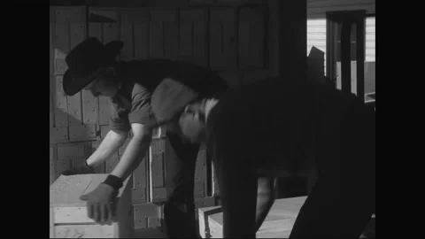 1940s: Men efficiently stack boxes. Workers diligently repair railroad car. 스톡 동영상 155525705