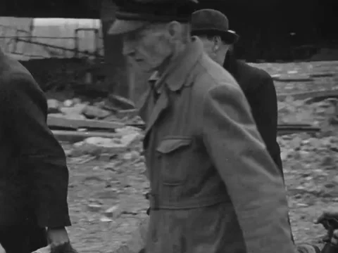 1940s: Men load corpse onto stretcher Stock Footage 229795973
