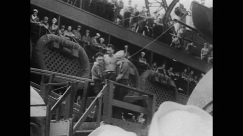 1940s: Men load wounded man on stretcher into ambulance. Men carry injured man Video stock 152992484