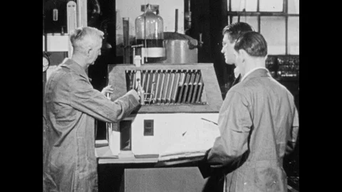 1940s: Men look over model of house with HVAC unit in attic. Stock Footage 106415825