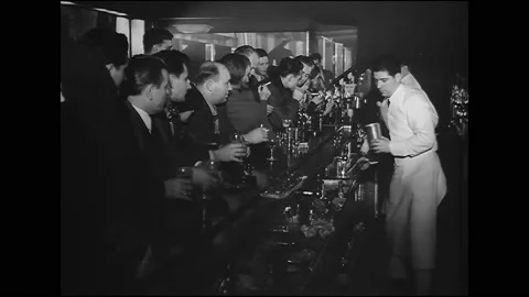 1940s - Men order drinks at the bar of Eddie Condon's nightclub. Stock Footage 170561419
