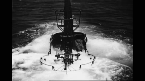 1940s: Men work in control room.  Submarine sinks underwater.  Periscope rises.  Stock Footage 167370247