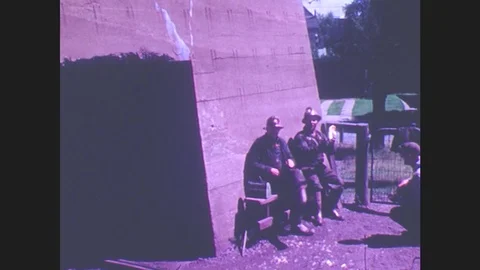 1940s: Miners in hardhats sit around having lunch, eating sandwiches. A boy sits Stock Footage