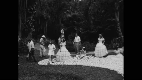 1940s: Models posing in the garden among a large design made of fruit. Elements Stockbeeldmateriaal 236170584
