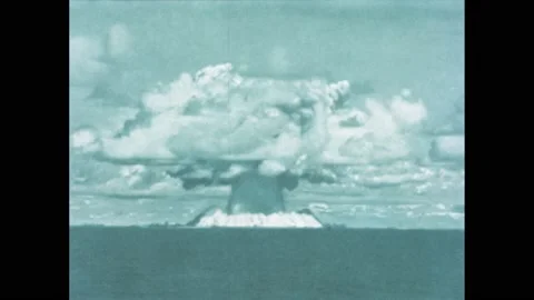 1940s: Mushroom cloud of a nuclear explosion. Scientist adjusting test Stock Footage 195117612
