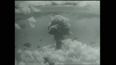 1940s: Mushroom cloud rises over ships. Stock Footage 153551728