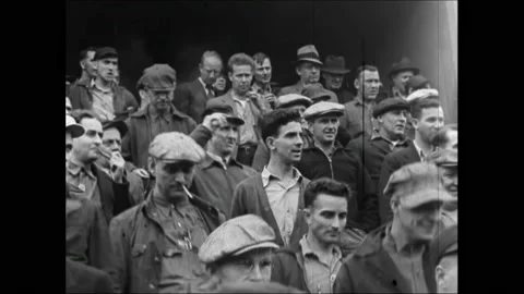 1940s: Newspaper headline. Workers exiting factory. Stack of newspapers. Man Stock Footage 162327165