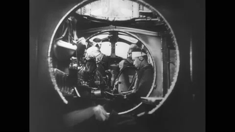 1940s Pacific Ocean: Bomber plane crew plot course and consult map. Man climbs Vídeos de archivo 143411287