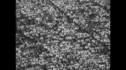 1940s: Packed stadium.  Men play football.  Man scores touchdown.  Referee makes Stock Footage 124337554