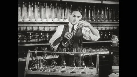 1940s: People at work in office. Men at work in lab. Men study map. Title card. Stock Footage 152532964
