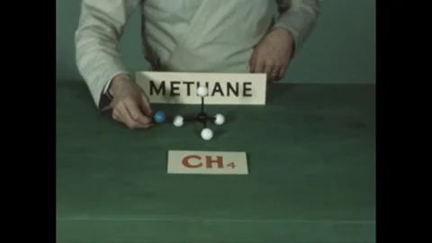 1940s: A person in a lab coat constructs a model of the methane molecule, Stock Footage 280687853