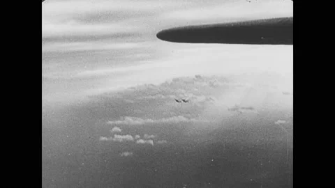 1940s: Planes drop bombs. Smoke rises from buildings. Man in airplane fires Vídeos de archivo 150349692